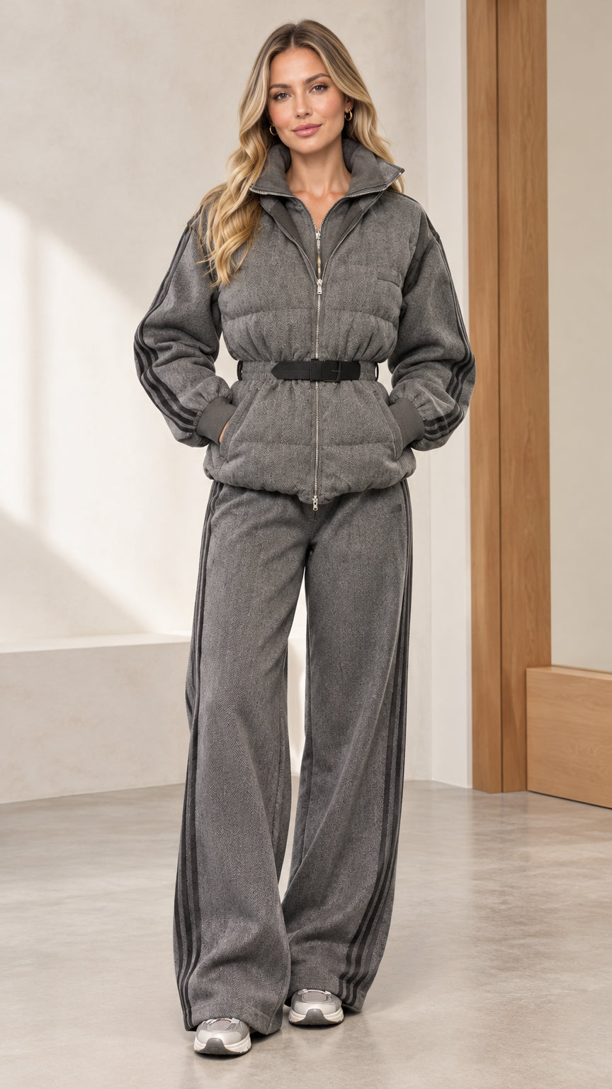 Front full view of woman wearing grey quilted belted puffer jacket and matching wide-leg track pants set