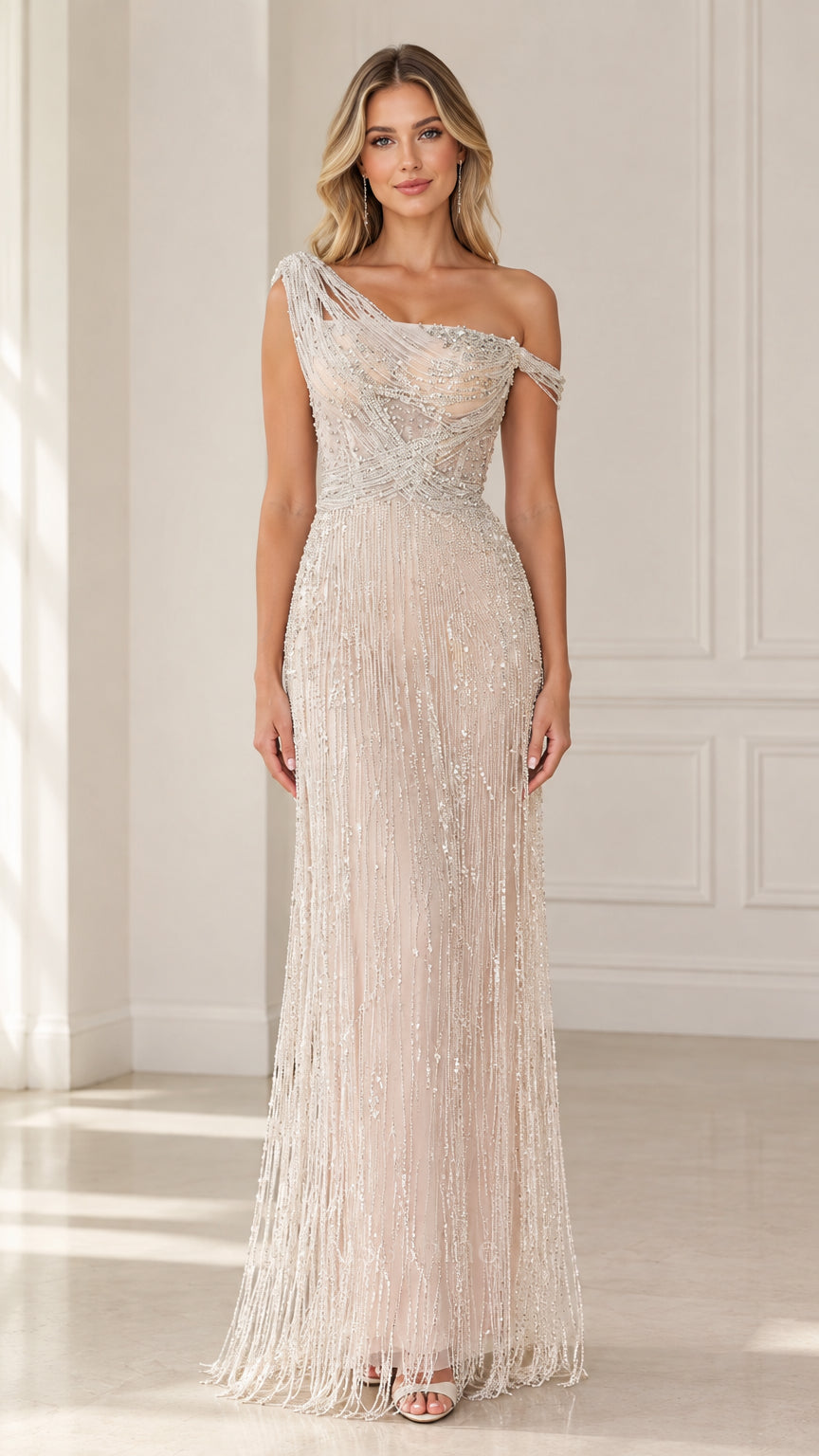 Front view of model wearing Champagne one-shoulder beaded fringe formal evening gown