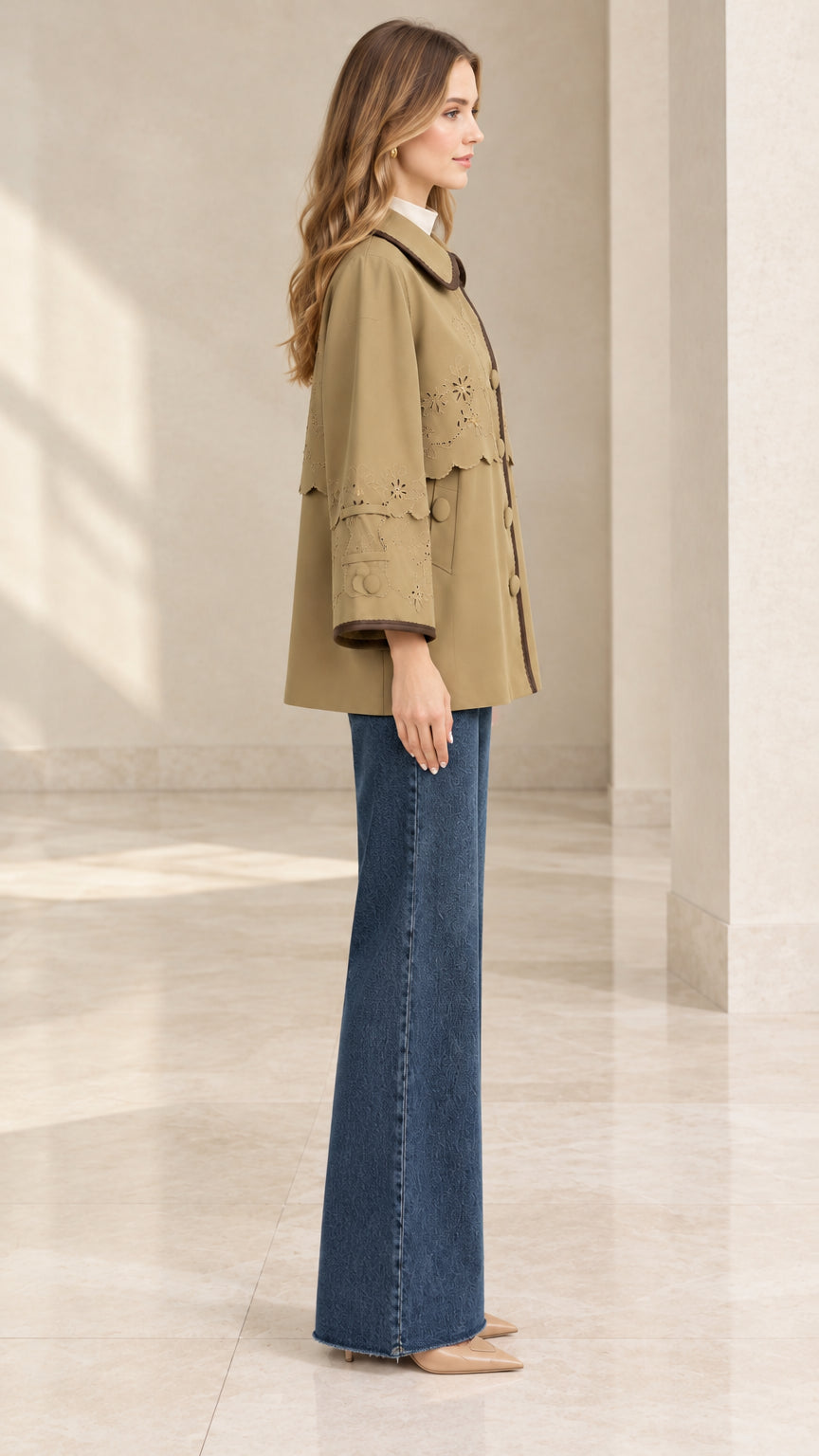 Side profile view of khaki embroidered capelet jacket showcasing relaxed A-line silhouette