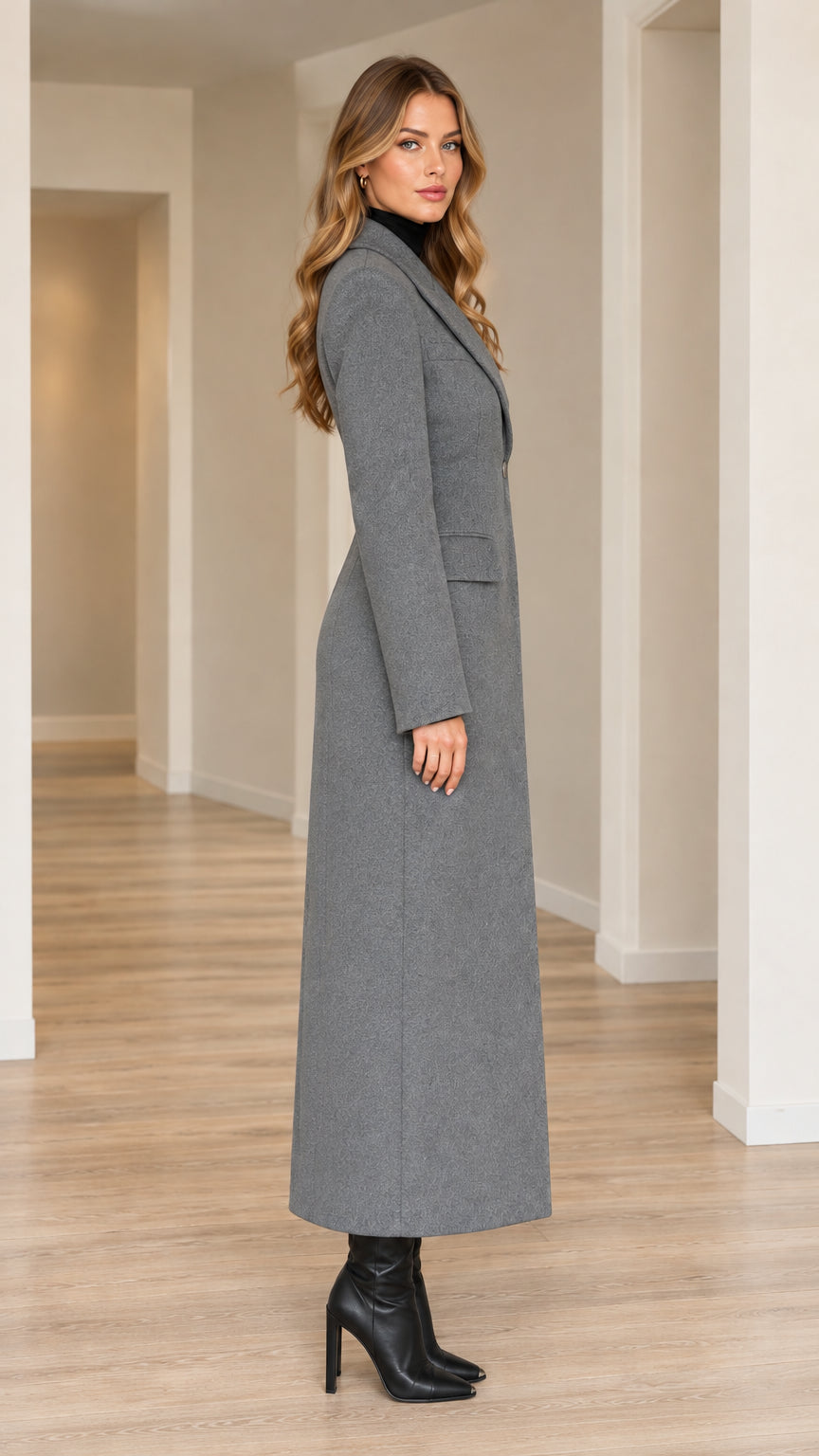 Side profile view of grey longline tailored overcoat showing ankle length