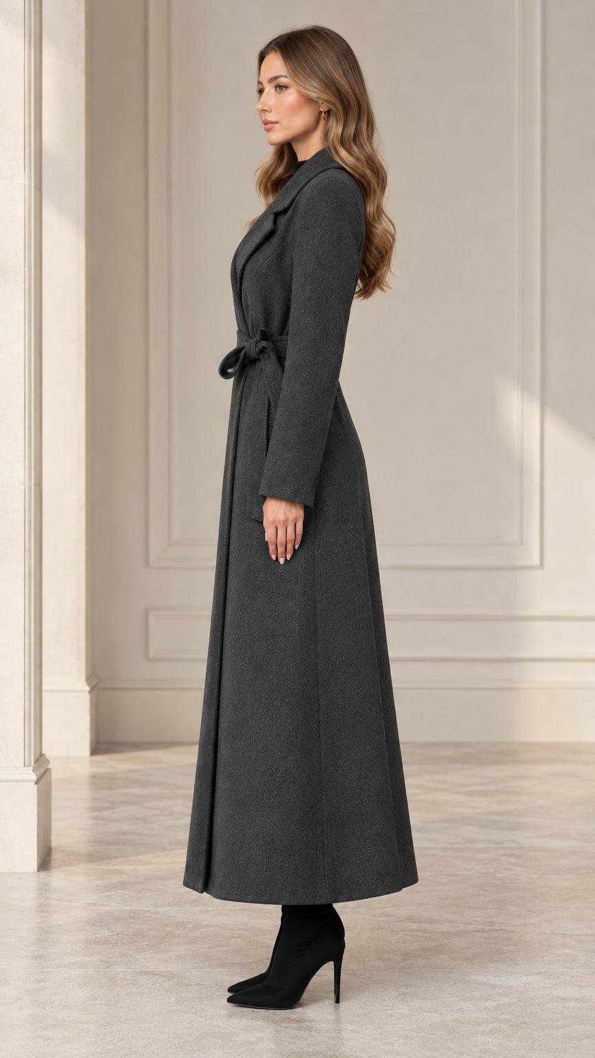 Side profile view of woman wearing the charcoal grey belted maxi coat
