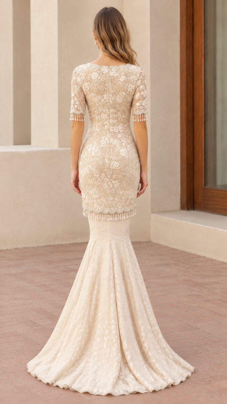 Back view of champagne lace mermaid evening dress showing tailored fit and flared hem