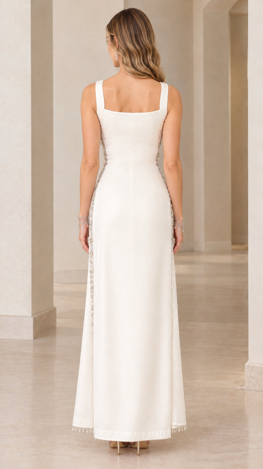 Back view of woman wearing ivory formal gown featuring square back neckline