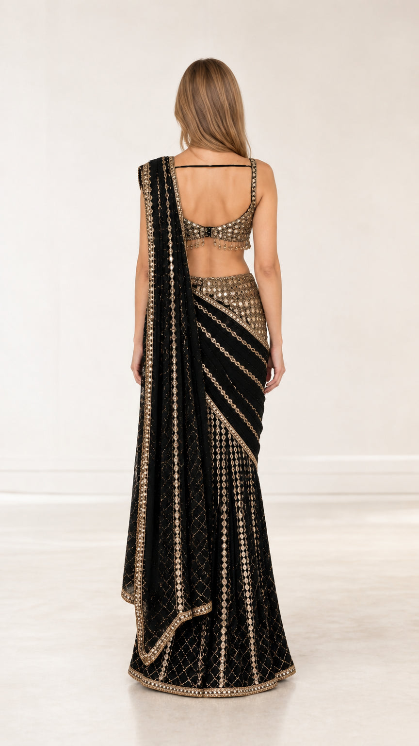 Back view of black pre-draped saree showcasing blouse back strap and pallu drape
