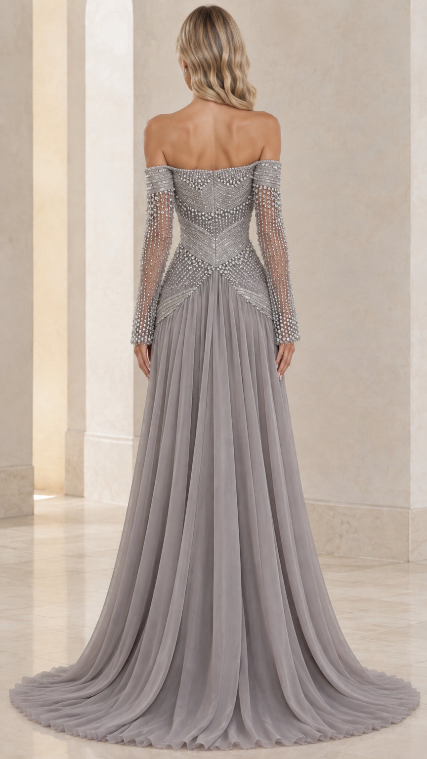 Back view of model showing off-the-shoulder back and flowing slate gray chiffon skirt