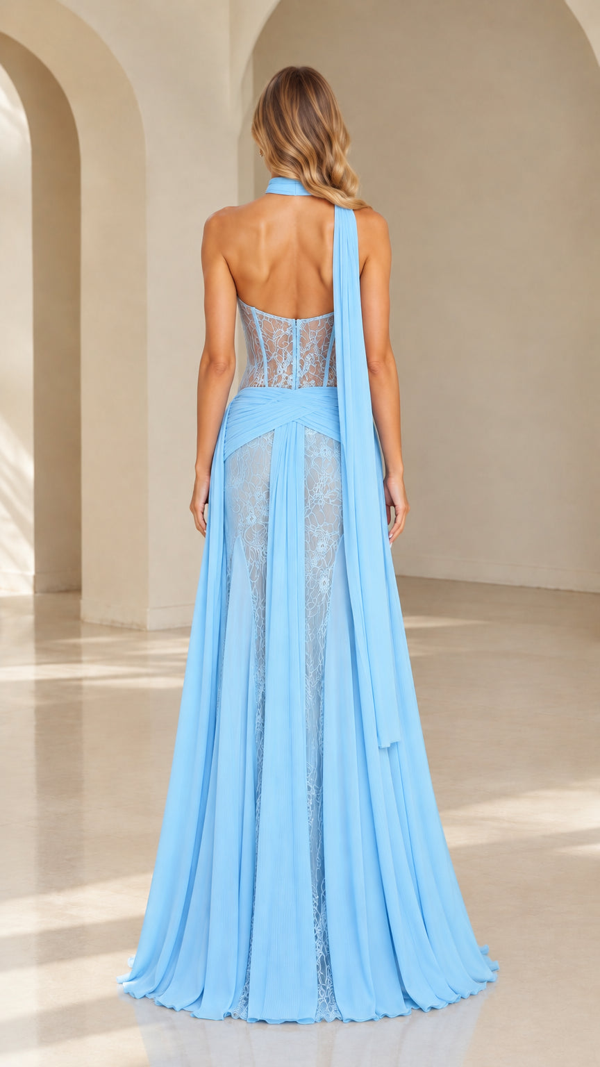 Back view of model in a sky blue halter lace evening gown showcasing the open back