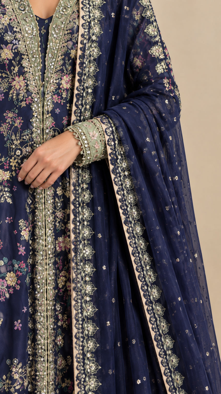 Close-up detail of navy blue gown floral embroidery and embellished borders