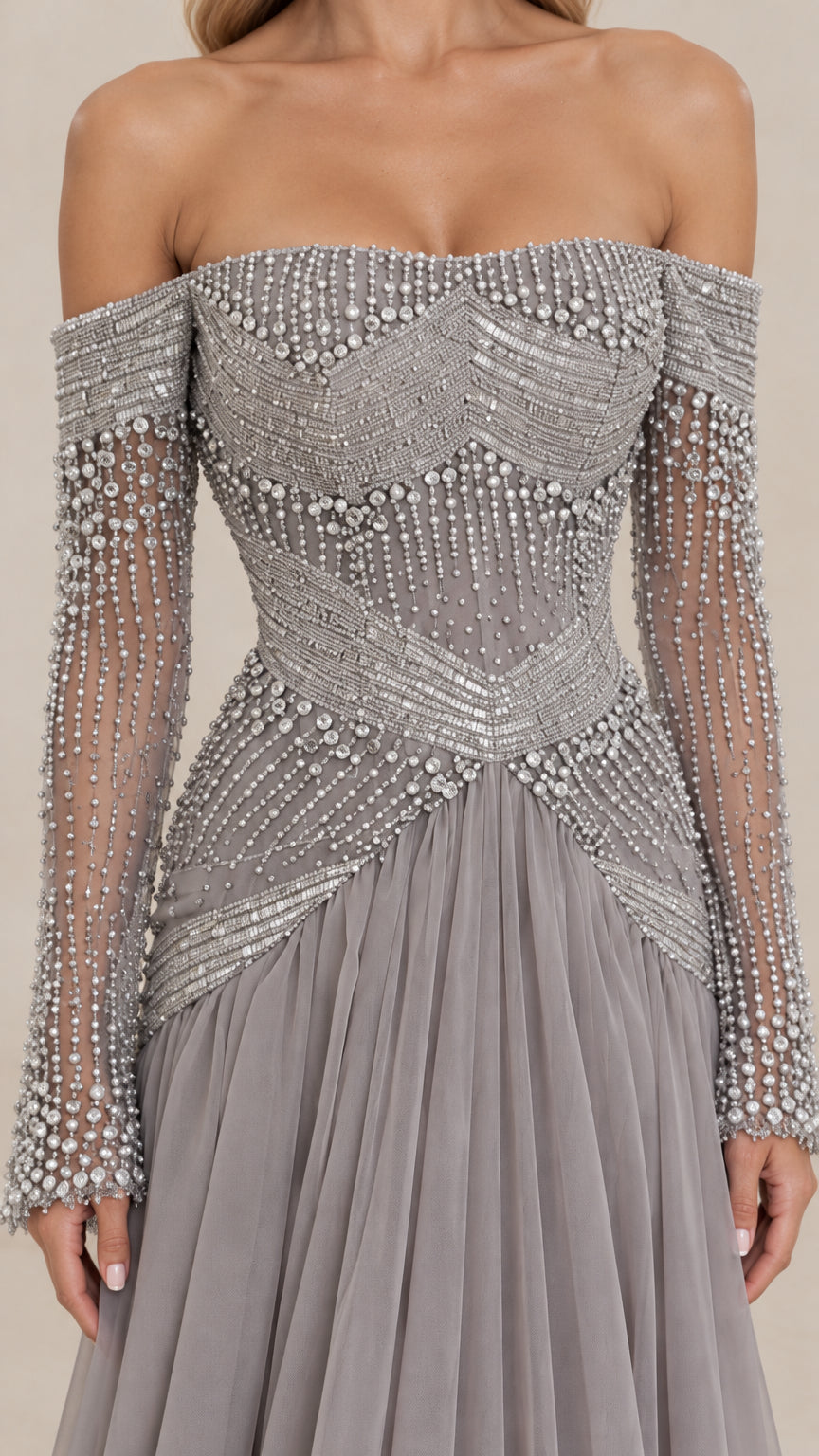 Close-up detail of geometric pearl and crystal-like beading on bodice and sleeves