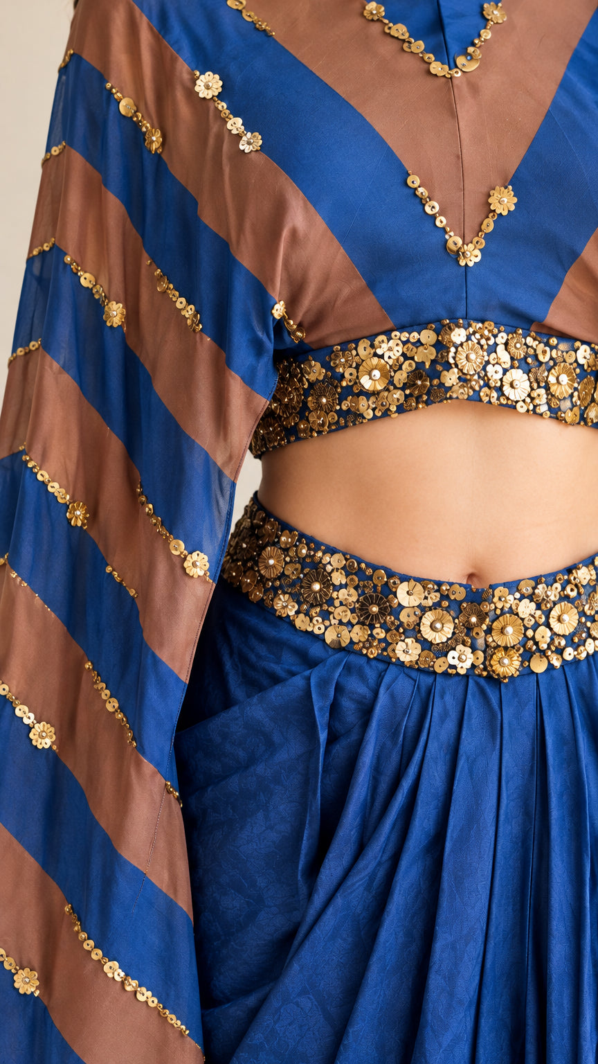 Close-up detail of sequin and bead embellishments on waist and striped sleeve fabric