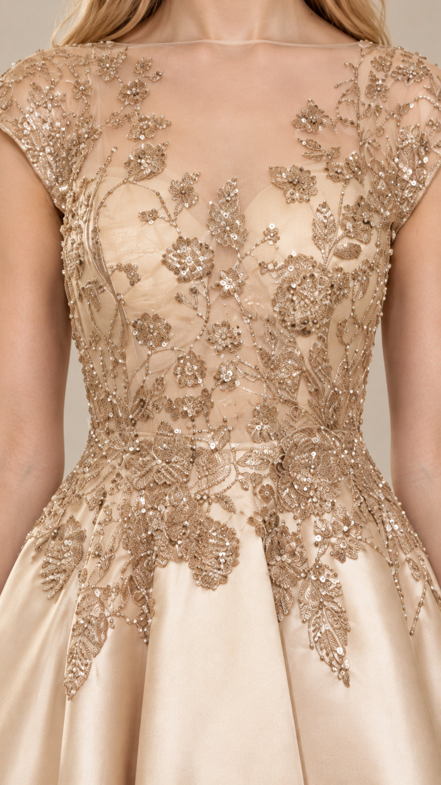 Close-up of intricate metallic floral embroidery on sheer mesh bodice