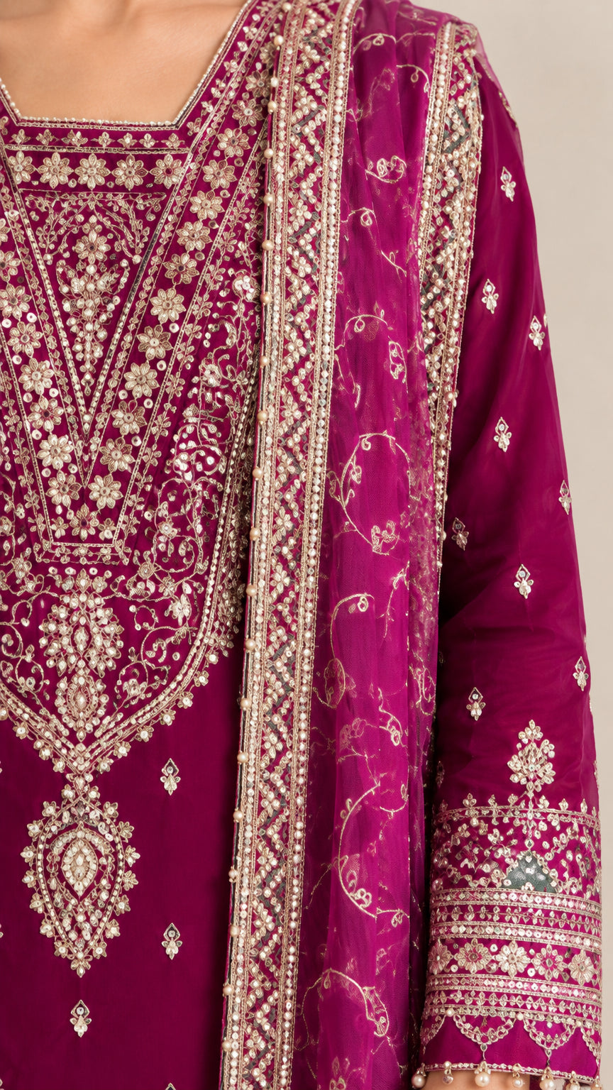 Close-up detail of ornate gold and silver embroidery on neckline and dupatta border