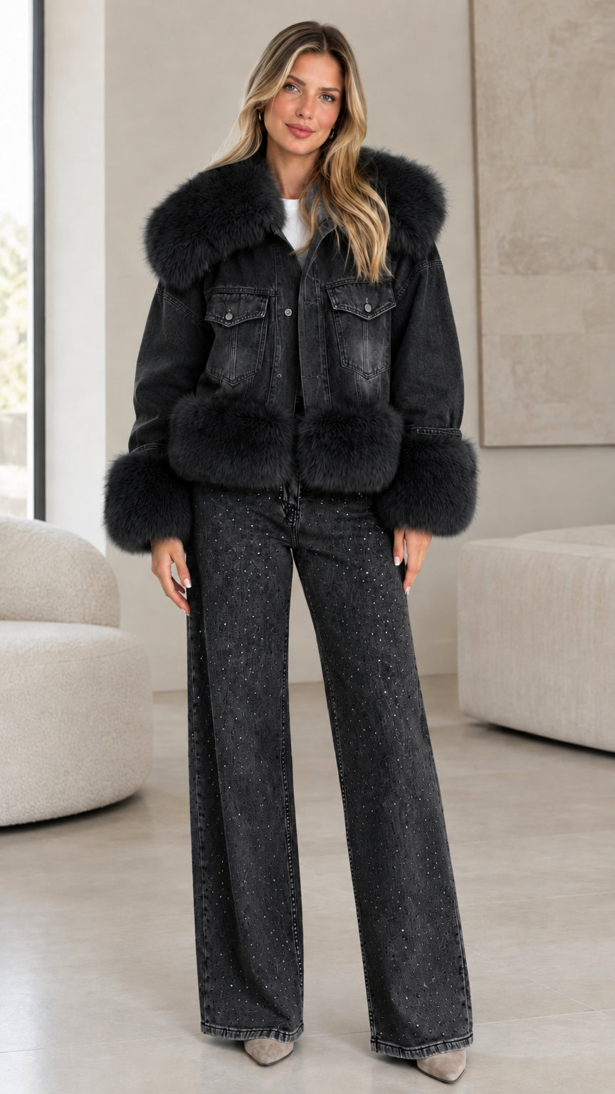 Model wearing black washed denim jacket with matching black faux fur trim and wide-leg jeans
