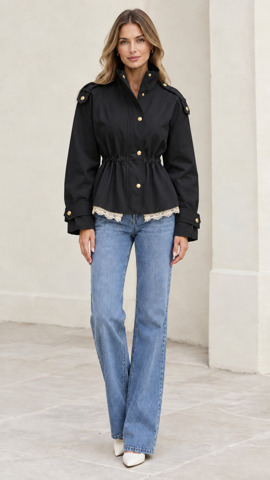 Model wearing black cinched waist utility jacket with gold buttons and lace trim
