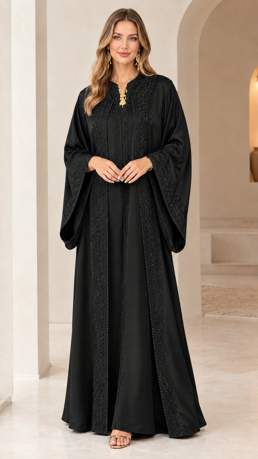 Front view of woman wearing black embroidered caftan maxi dress