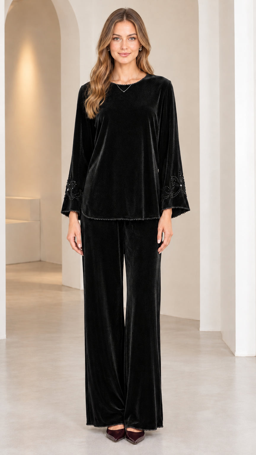 Model wearing Black velvet long-sleeve top and wide-leg pant set