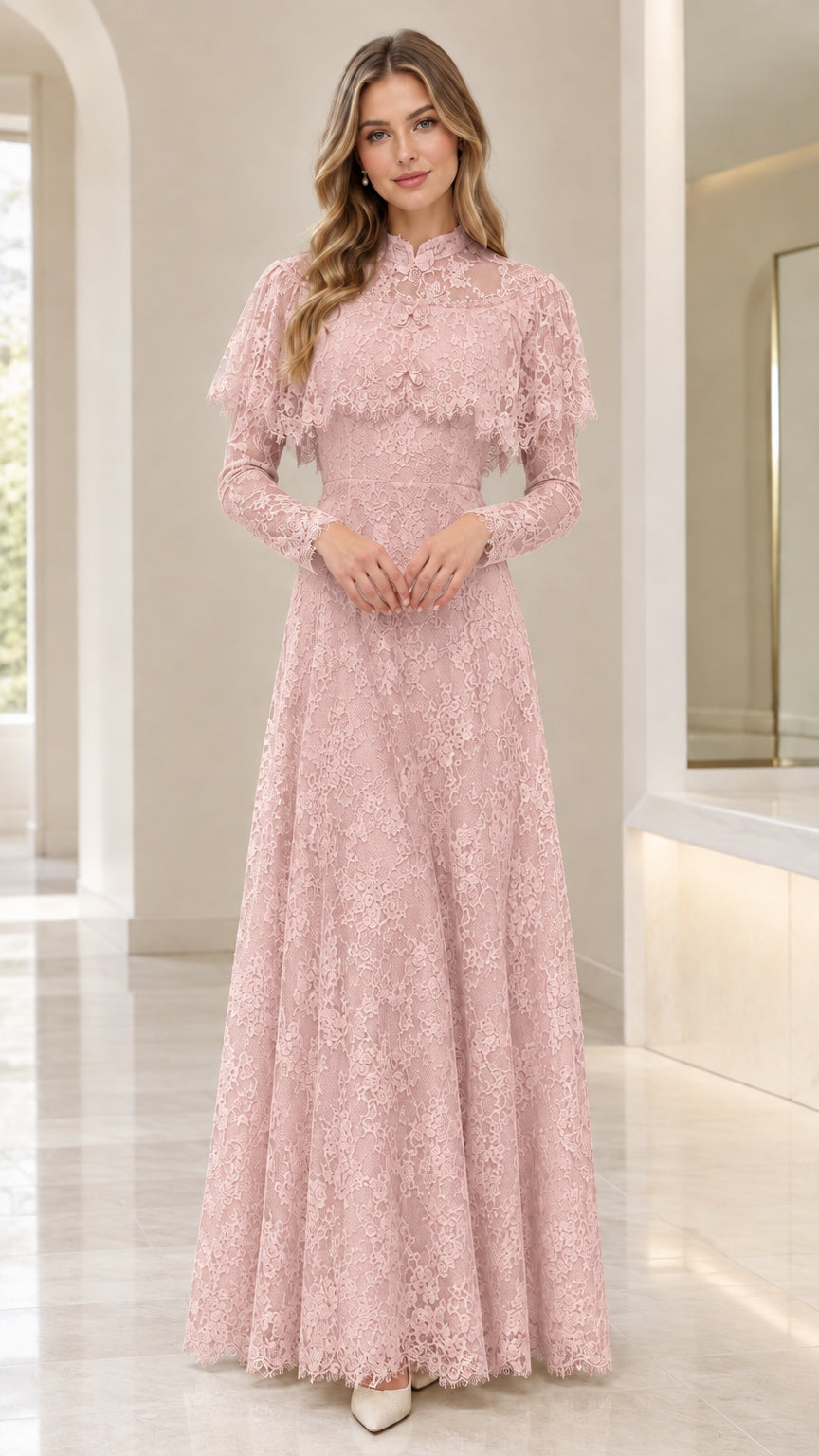 Front view of woman wearing blush pink lace capelet formal dress