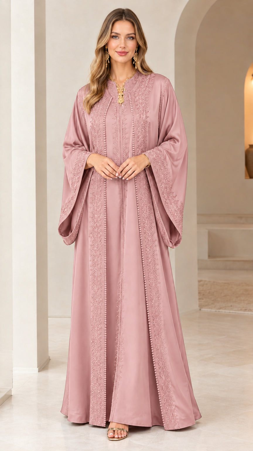 Front view of woman wearing dusty rose embroidered caftan maxi dress