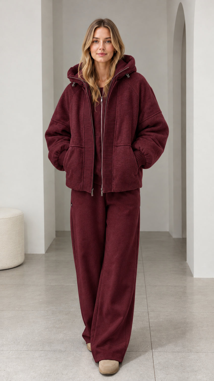 Front view of model wearing burgundy textured fleece hooded zip-up jacket