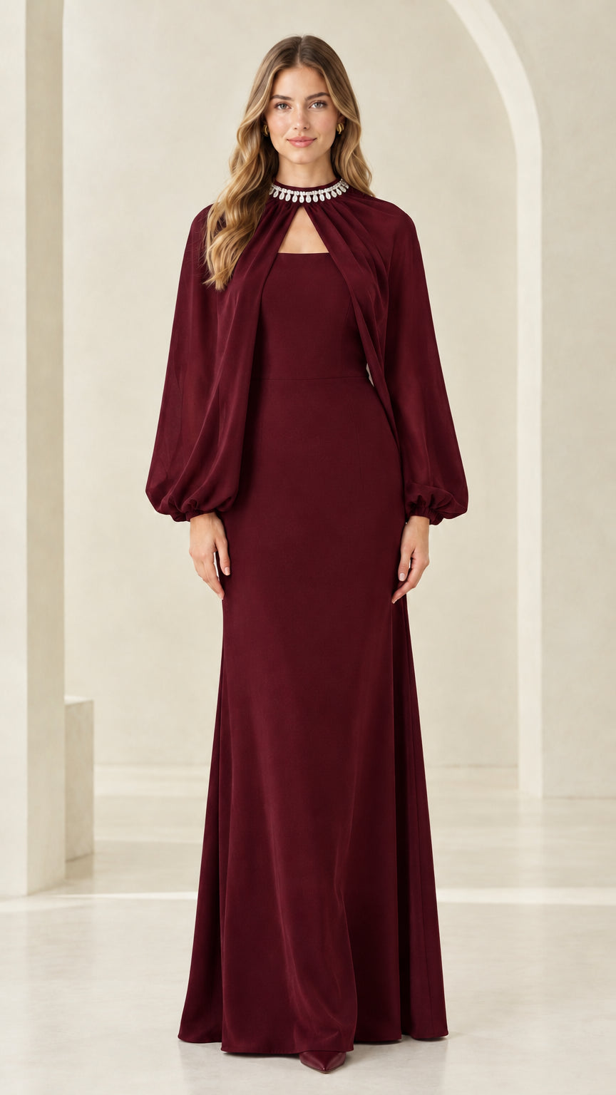 Front view of woman wearing burgundy wine rhinestone neckline cape evening dress