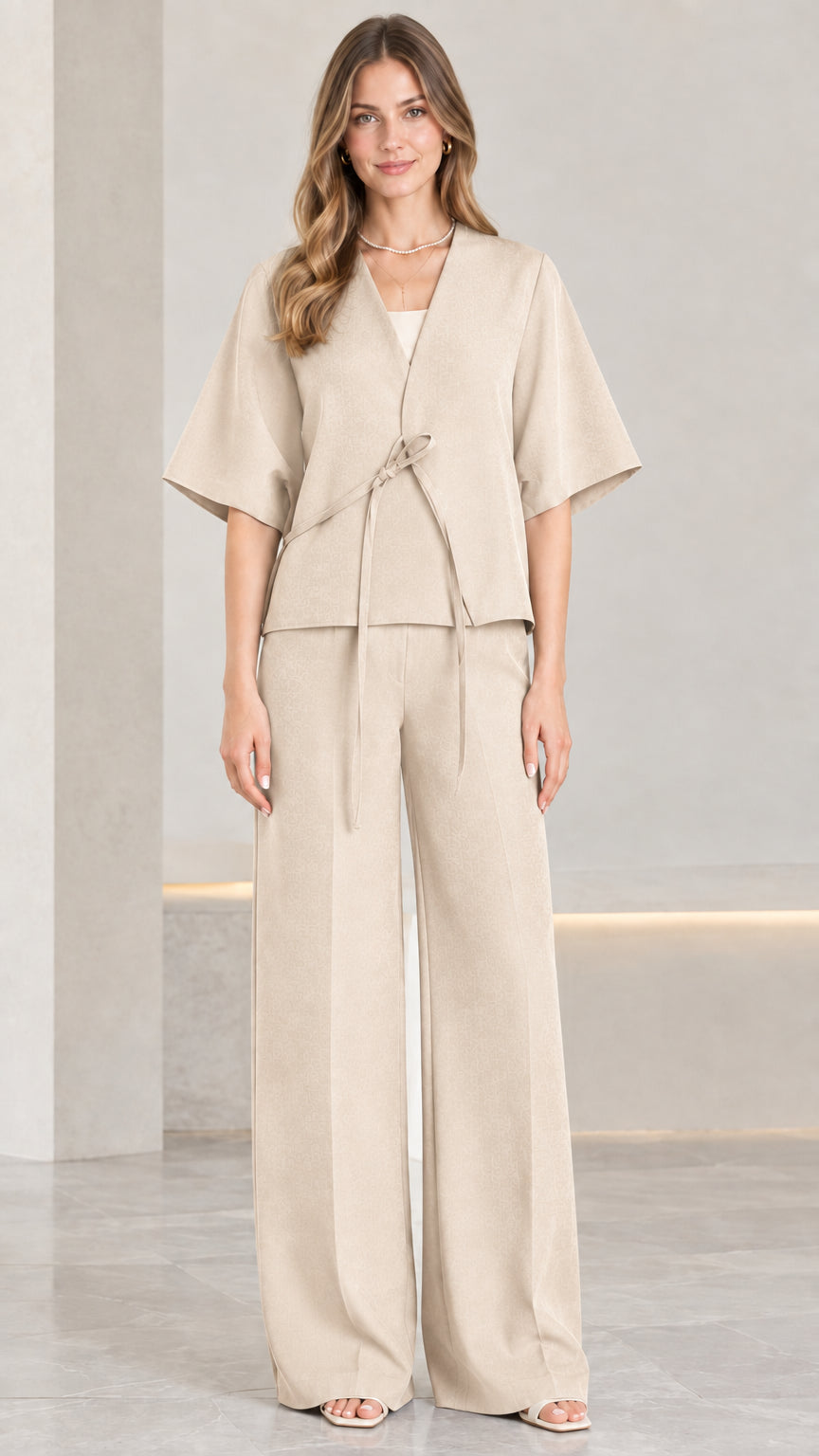 Front view of woman wearing beige tie-front kimono top and wide-leg pants set