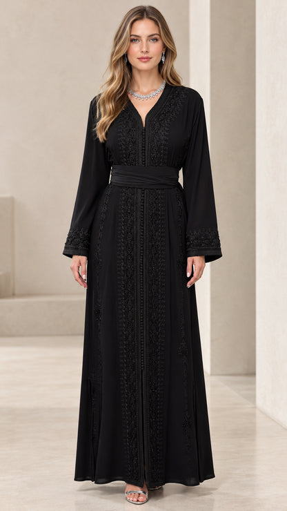 Full front view of black long sleeve embroidered kaftan maxi dress with waist belt