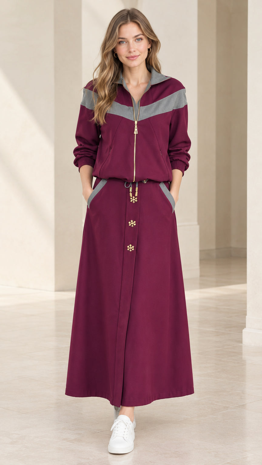Front view of model wearing burgundy chevron colorblock half-zip top and maxi skirt set