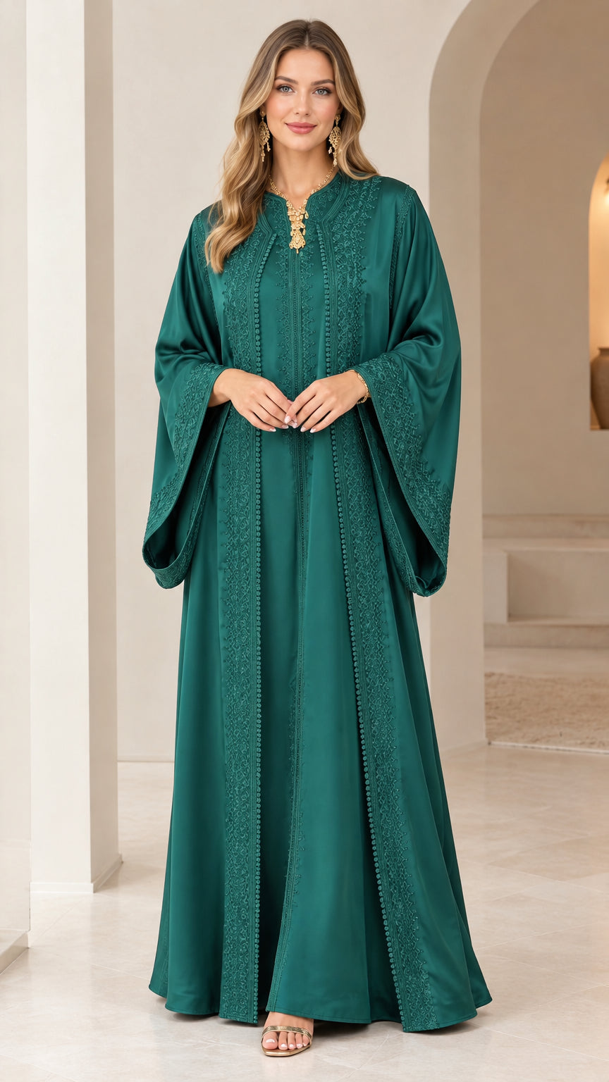Front view of woman wearing emerald green embroidered bell sleeve caftan dress