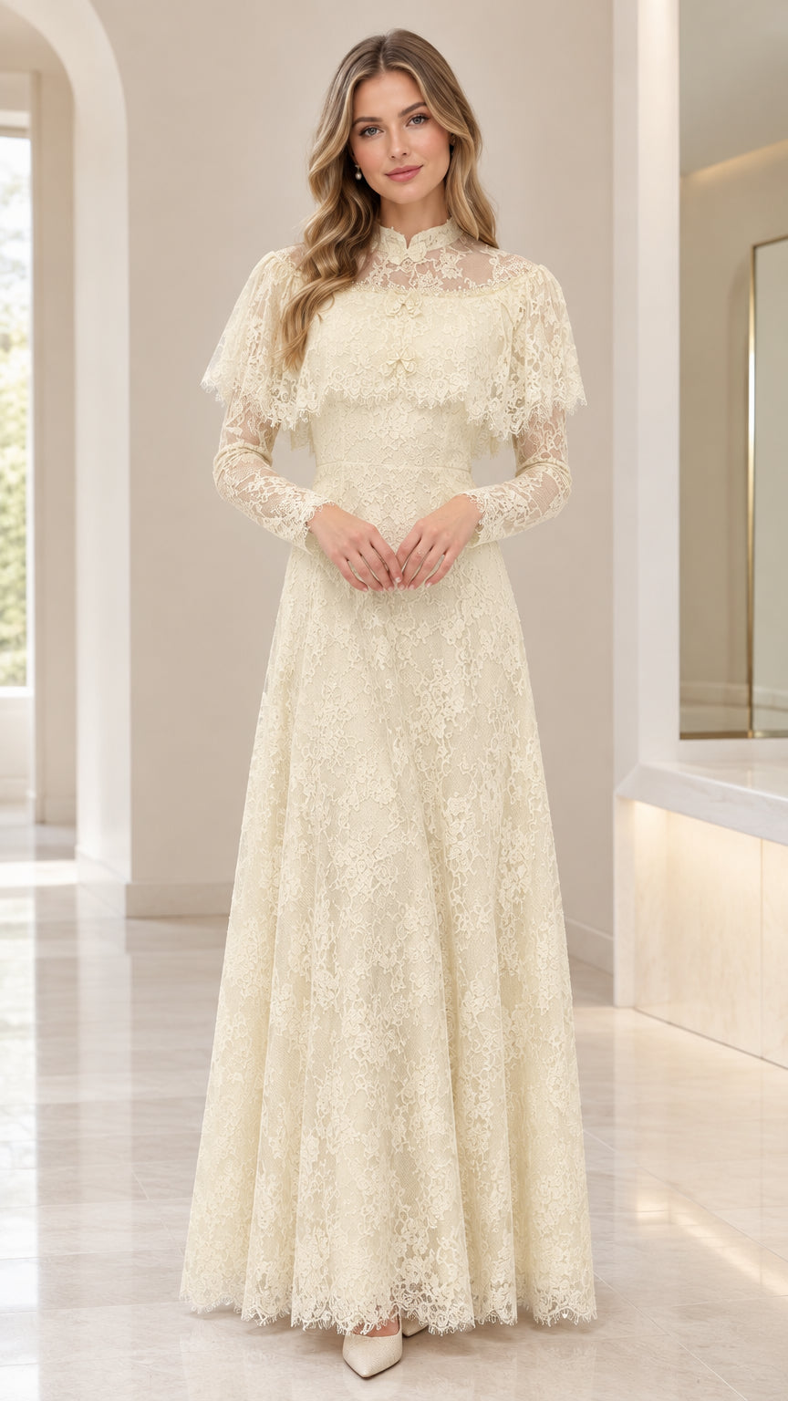Front view of woman wearing ivory lace capelet maxi dress