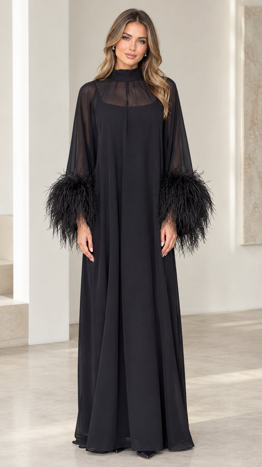 Front view of black mock neck maxi gown with sheer yoke and feather cuffs