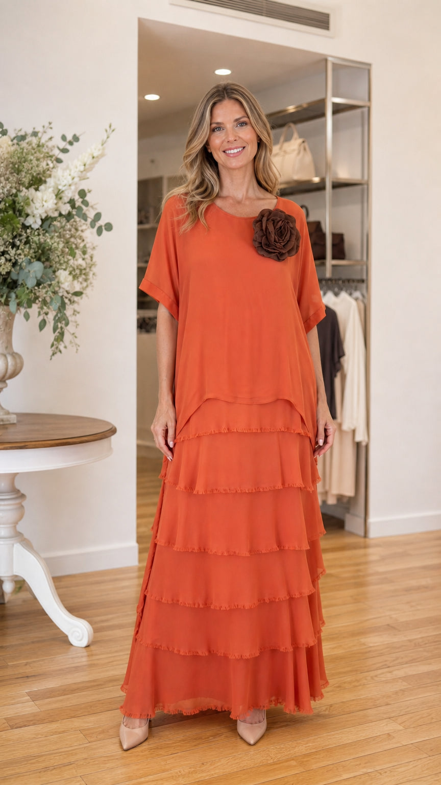 Front view of model wearing rust orange tiered ruffle maxi dress