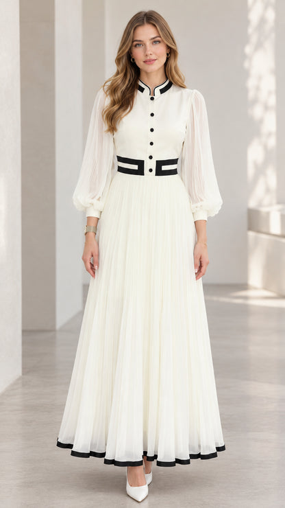 Front full-length view of woman wearing white pleated lantern sleeve maxi dress with black contrast trim