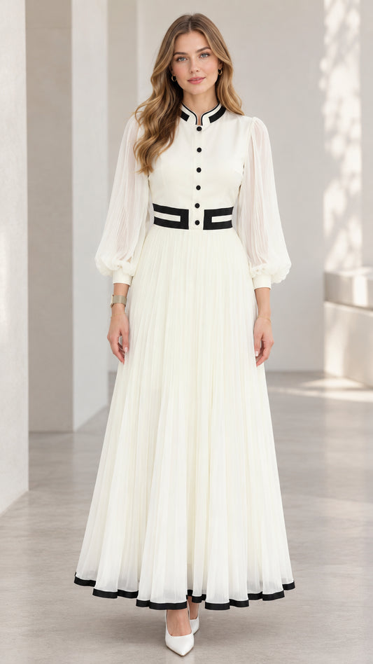 Front full-length view of woman wearing white pleated lantern sleeve maxi dress with black contrast trim