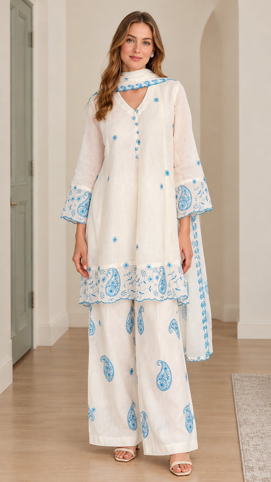 Front full-length view of model wearing white embroidered 3-piece tunic pant set with scarf