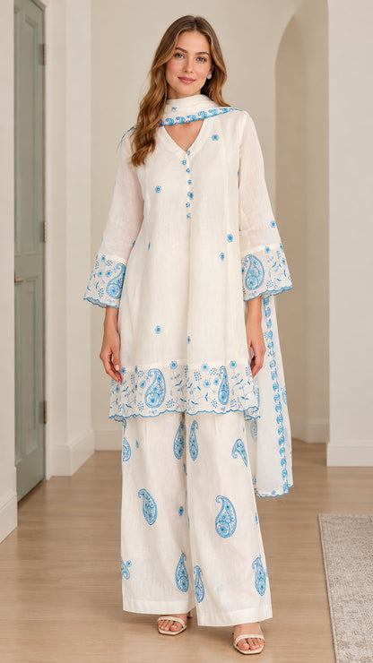 Front full-length view of model wearing white embroidered 3-piece tunic pant set with scarf