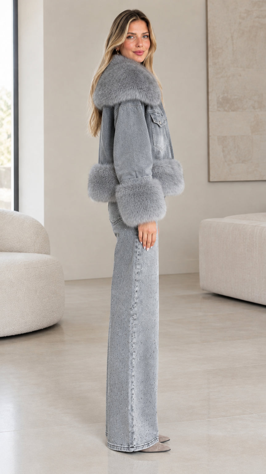 Side profile view of model wearing grey faux fur trim denim jacket and wide-leg pants