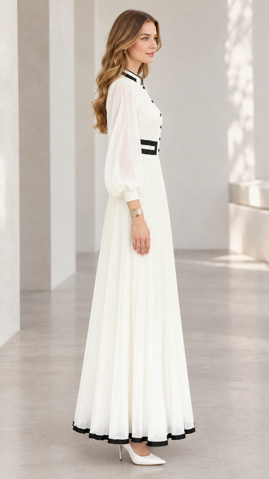 Side profile view of white long sleeve pleated A-line maxi dress