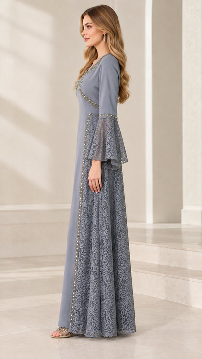 Side profile view of the dusty blue floor-length gown showing lace side inserts