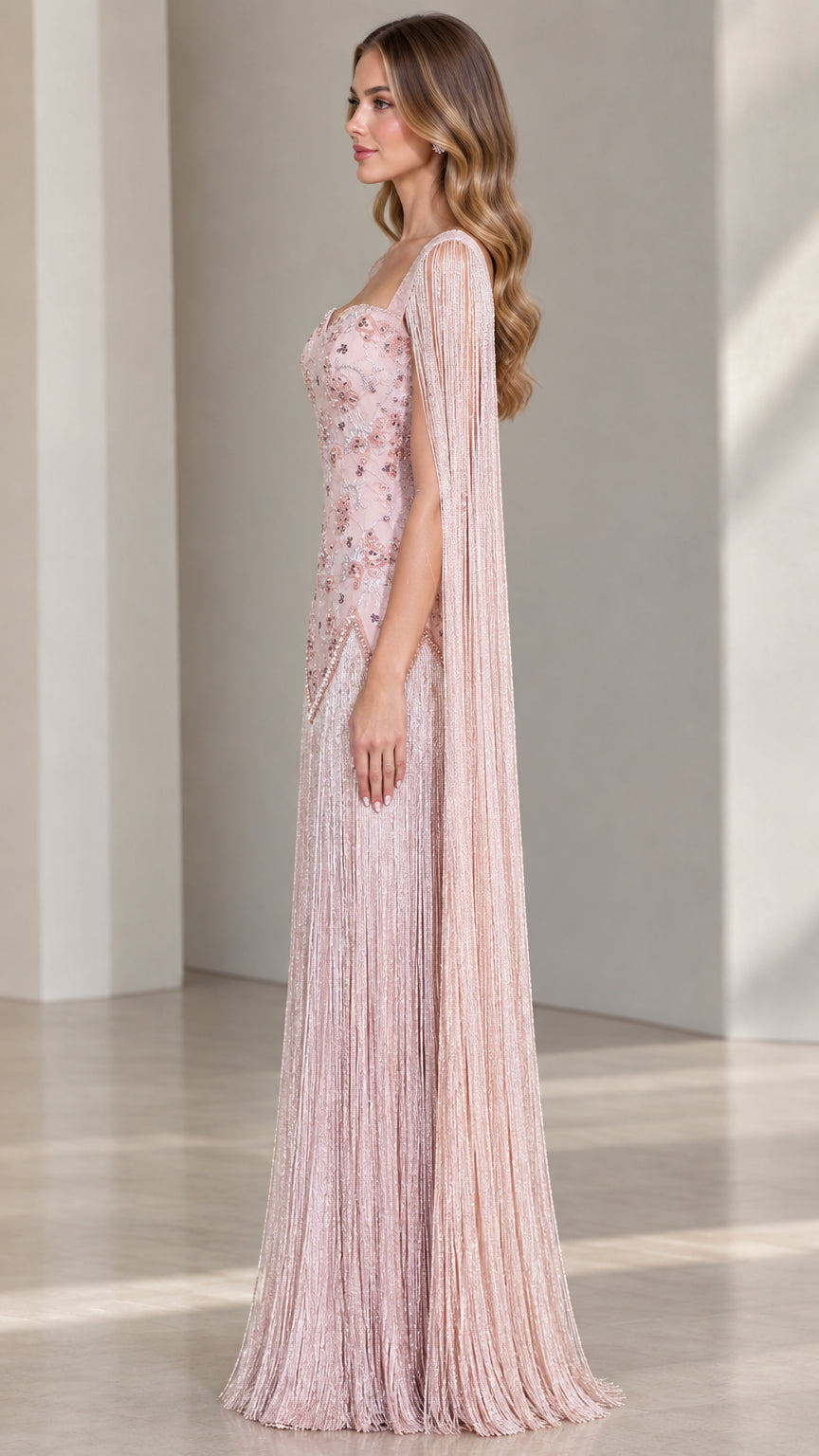 Side profile of dusty pink floor-length fringe cape formal dress