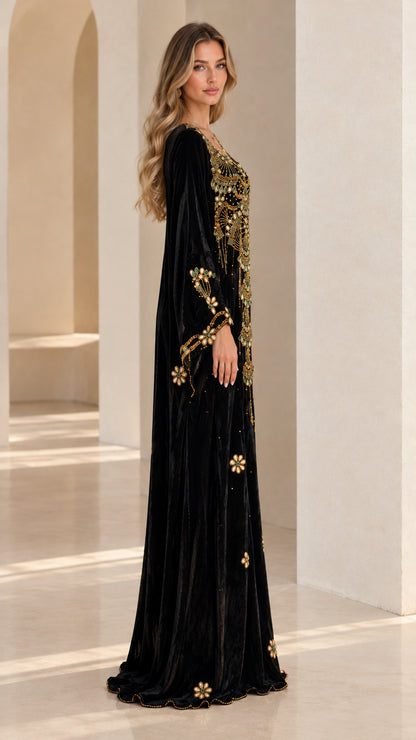 Side profile view of woman wearing Black velvet kaftan maxi dress with embroidered sleeves