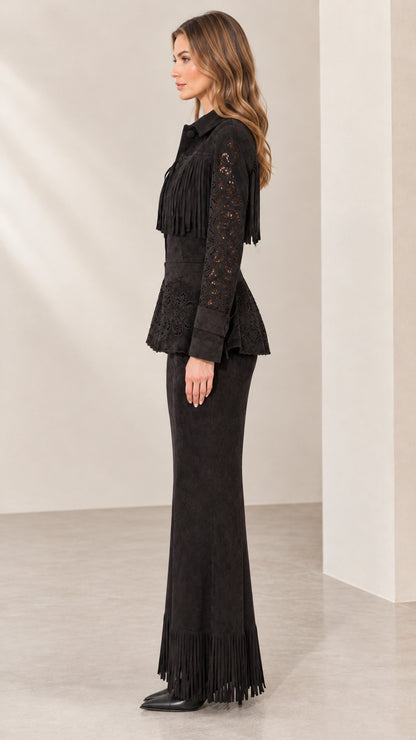 Side view of model wearing black western fringe peplum jacket and maxi skirt
