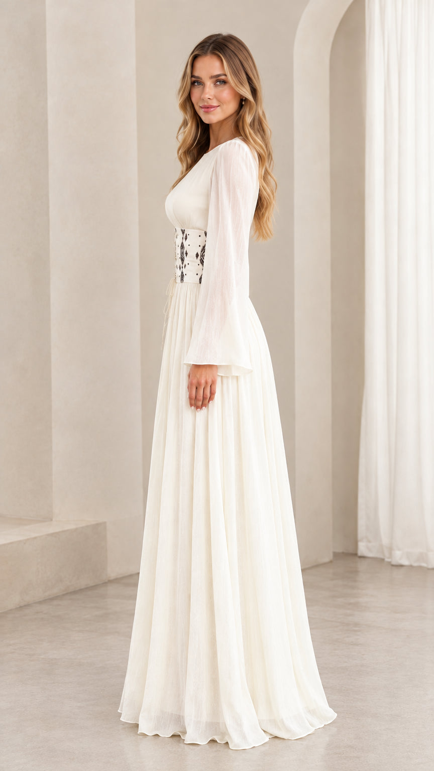 Side profile view of ivory chiffon maxi dress showing bell sleeves and flowing pleated skirt
