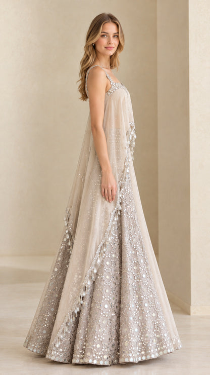Side profile of champagne sheer cape overlay formal gown