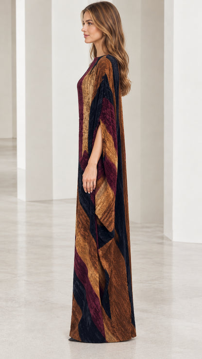 Side angle view of model wearing textured burgundy multi cape sleeve maxi gown