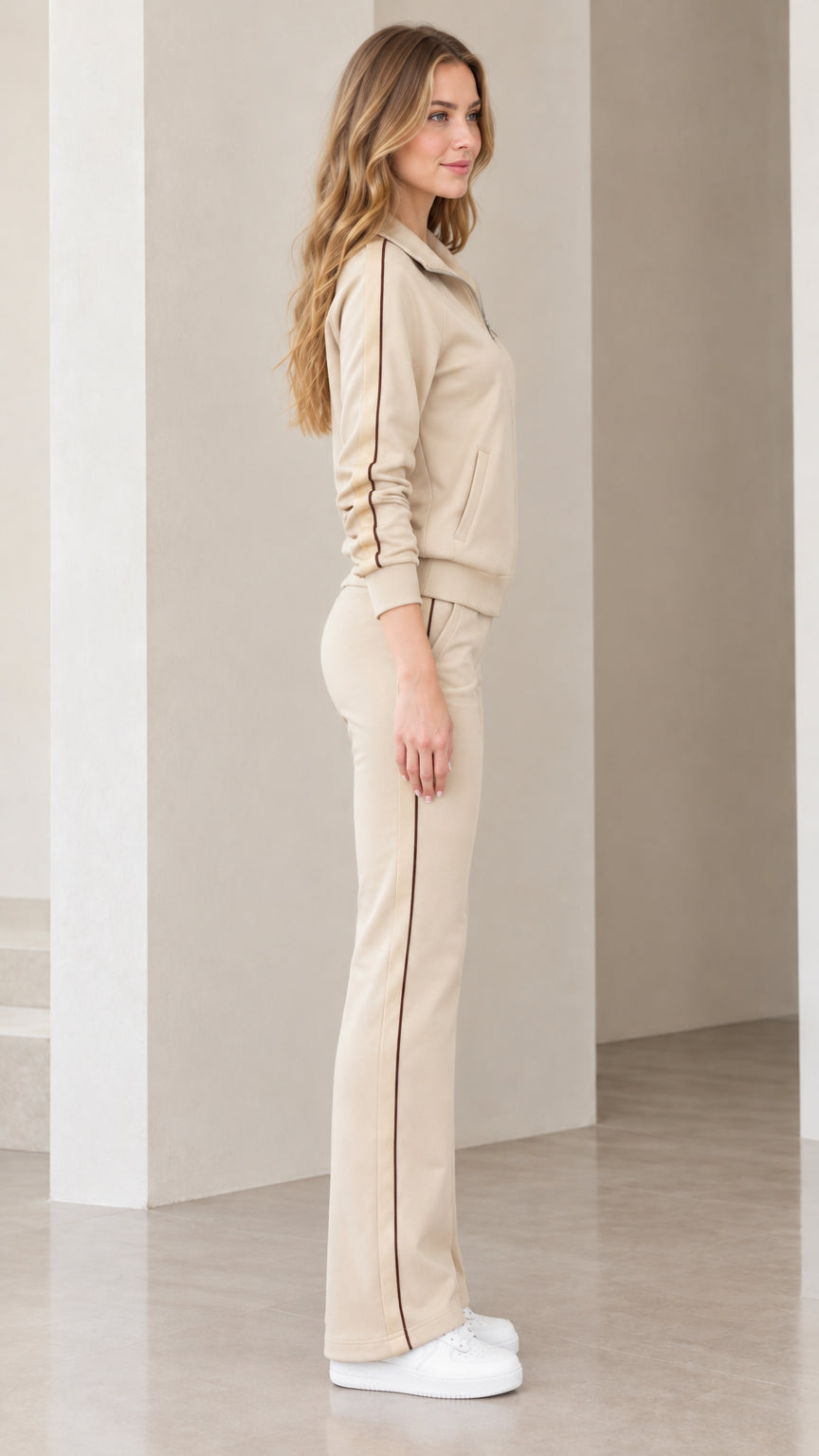 Side view of beige tracksuit set showing contrast vertical stripes along jacket and pants