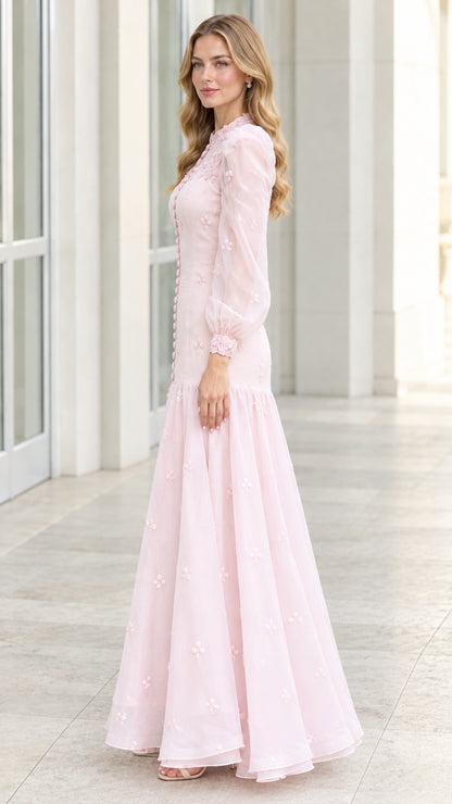 Side profile view of blush pink floral embroidered evening dress with sheer bishop sleeves