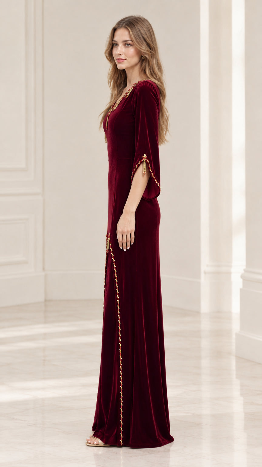 Side view of woman wearing Burgundy velvet floor length evening gown