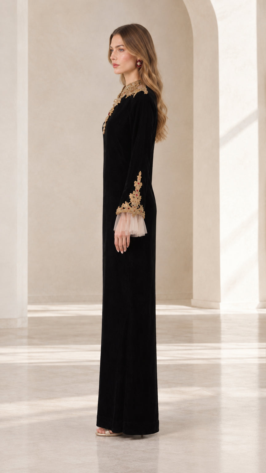 Side profile of elegant black long sleeve velvet evening gown