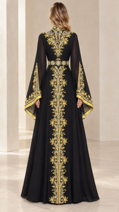 Back view of black caftan dress highlighting ornate center embroidery