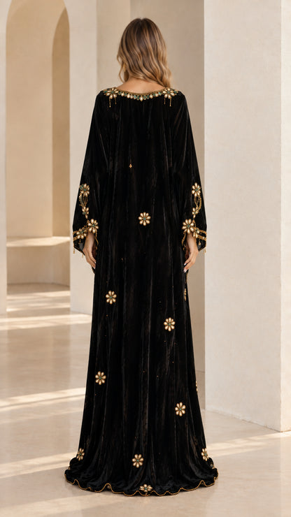 Back view of woman wearing Black velvet kaftan dress with scattered floral embellishments