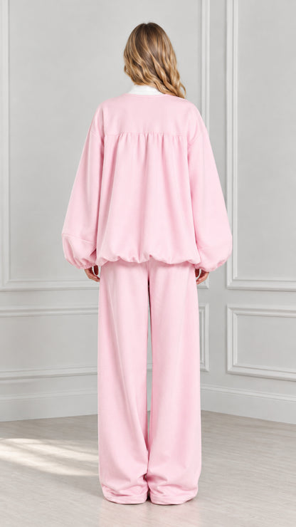Back view of light pink gathered zip-up jacket and matching wide-leg trousers